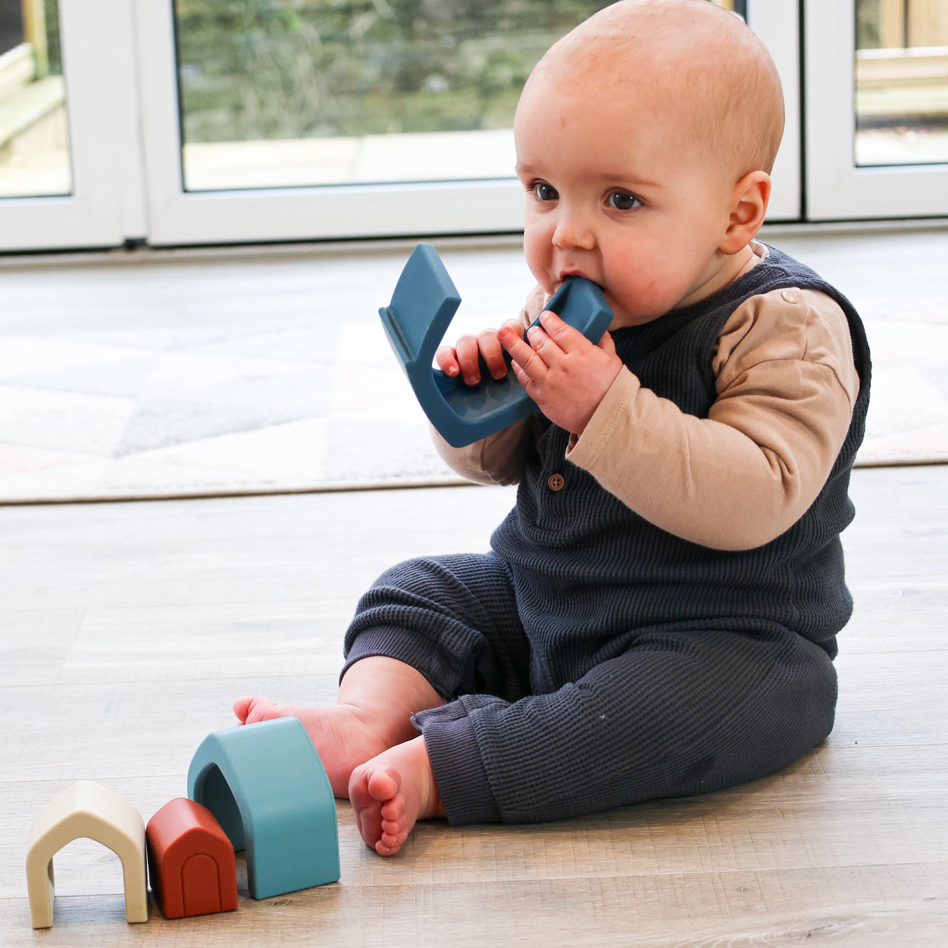 Colorful silicone stacking houses for babies from Baby Ellor Store, arranged in a playful tower on a white background.