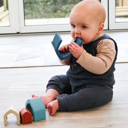 Colorful silicone stacking houses for babies from Baby Ellor Store, arranged in a playful tower on a white background.