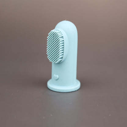 Baby Ellor silicone finger toothbrush for babies and toddlers, showing soft bristles on a child's finger for gentle oral cleaning.