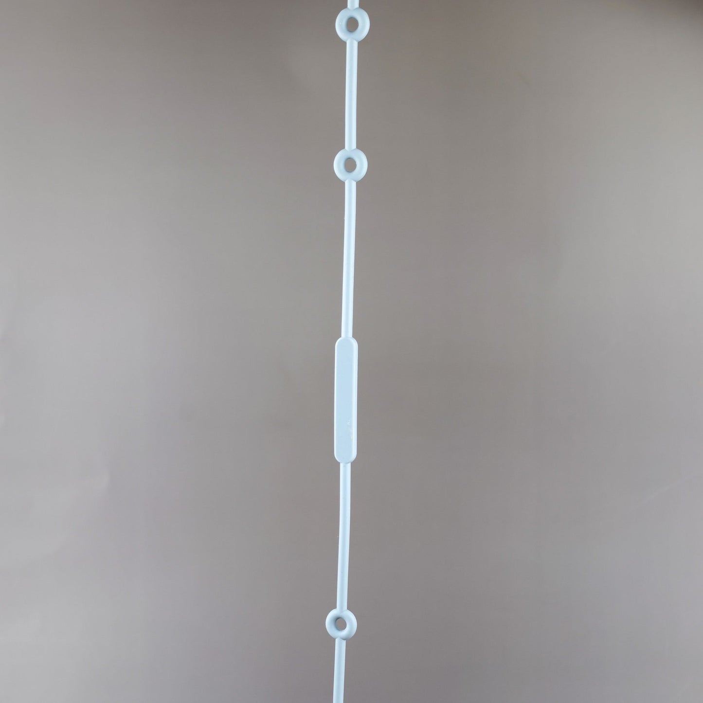 A silicone pacifier strap with a clip and chain design, featuring a pacifier attached to it.