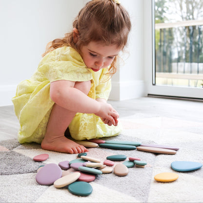 Baby Ellor silicone stacking pebbles set with 36 colorful, smooth, and flexible toy pebbles for babies and toddlers.