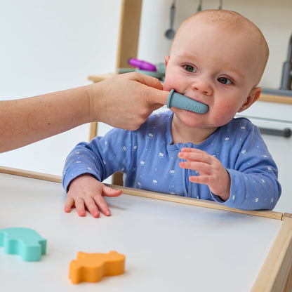 Baby Ellor silicone finger toothbrush for babies and toddlers, showing soft, flexible bristles on a small finger brush.