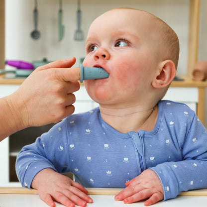 Baby Ellor silicone finger toothbrush for babies and toddlers, soft brush with gentle bristles on a child's tiny finger.