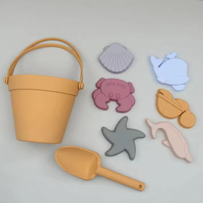 Baby Ellor silicone bucket and spade set with six shape molds, ideal for sandcastle building and outdoor play.