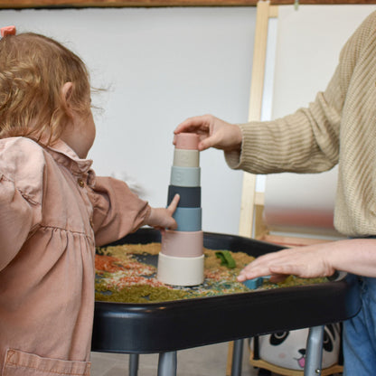 Colorful silicone stacking cups toy by Ellor & Co. for children, arranged in a stack on a white background.