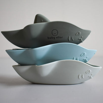 Baby Ellor silicone shark boats bath toy floating in water, colorful and soft for children's bath play.