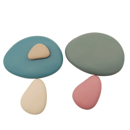 Baby Ellor silicone stacking pebbles, 36-piece set, colorful flexible toys for infants and toddlers, shown in a neat stack.
