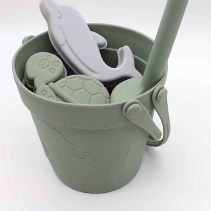 Baby Ellor silicone bucket and spades set with six shape molds, perfect for beach play and building sandcastles.