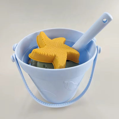 Baby Ellor silicone bucket and spades set with six shape molds, perfect for kids' beach or sand play activities.