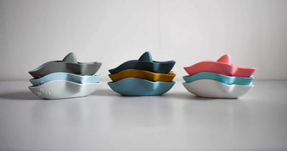 Baby Ellor silicone shark boats bath toy floating in water, colorful and soft for children's bath play.
