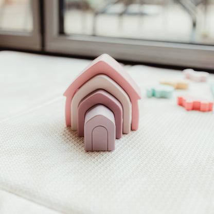 Colorful silicone stacking houses for babies, featuring multiple sizes and shapes, perfect for early development and play.