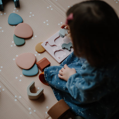 Child playing with colorful silicone animal shape sorter 