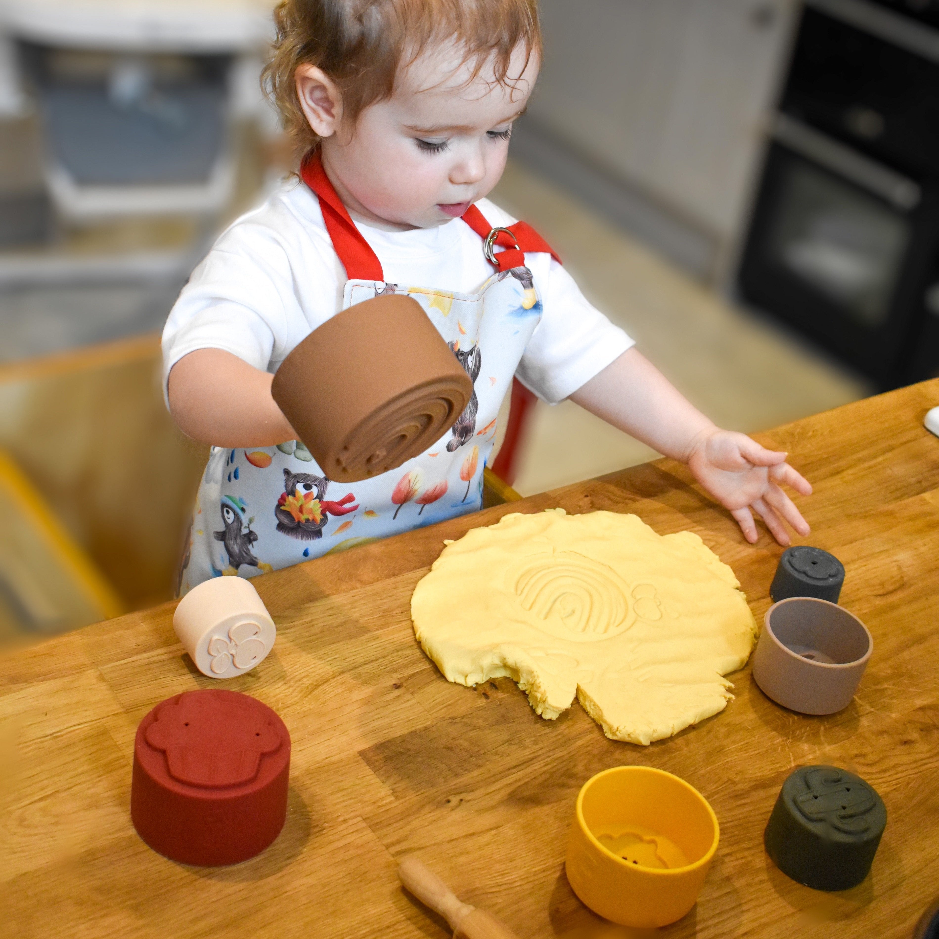 Colorful silicone stacking cups by Ellor & Co. arranged in a playful tower, ideal for kids' toys and games.