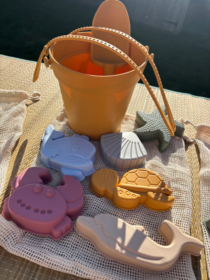 Baby Ellor silicone bucket and spades set with six shape molds, perfect for kids' beach or sandbox play.